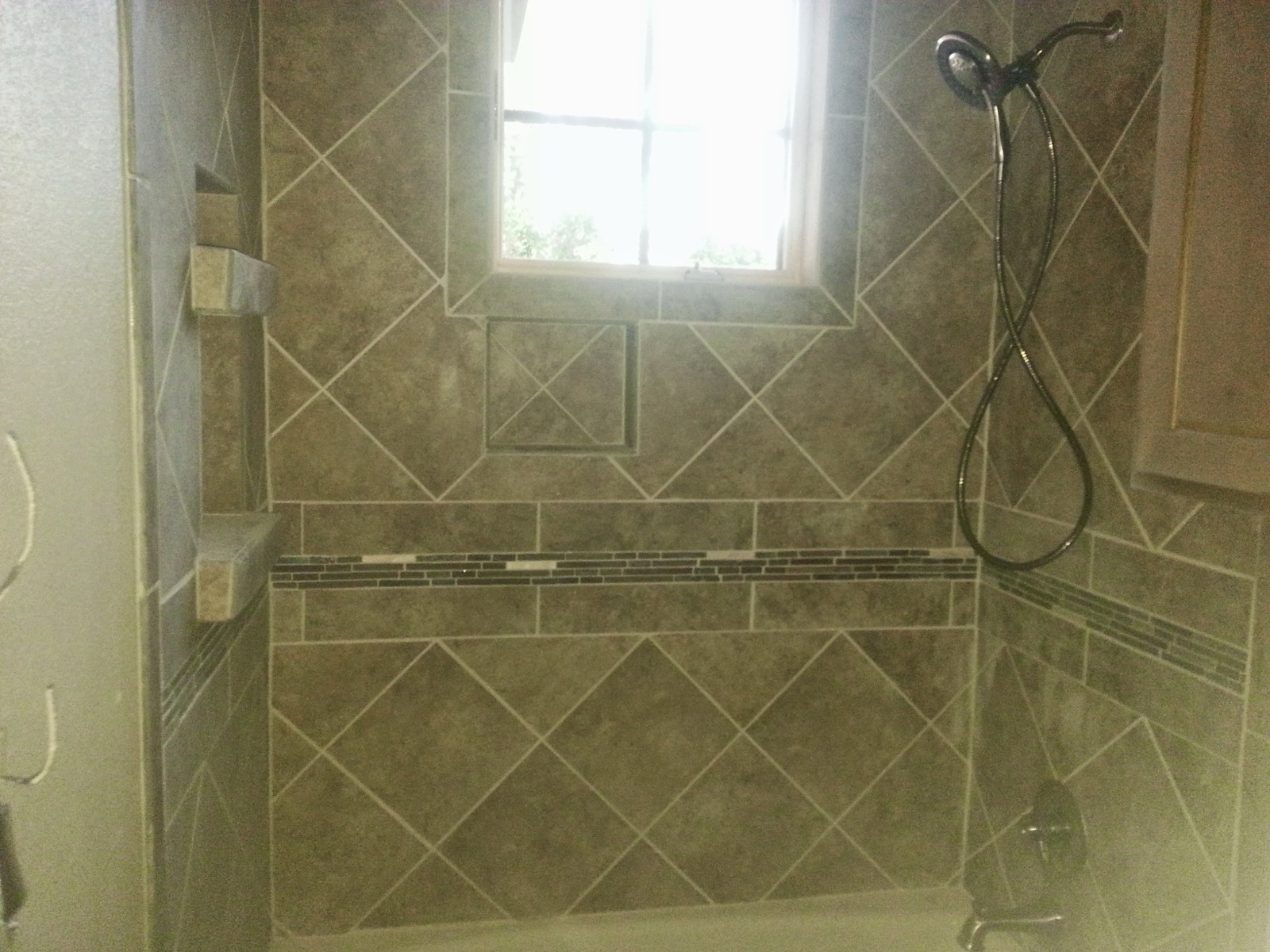 Diagonal-set tile shower with an interior window