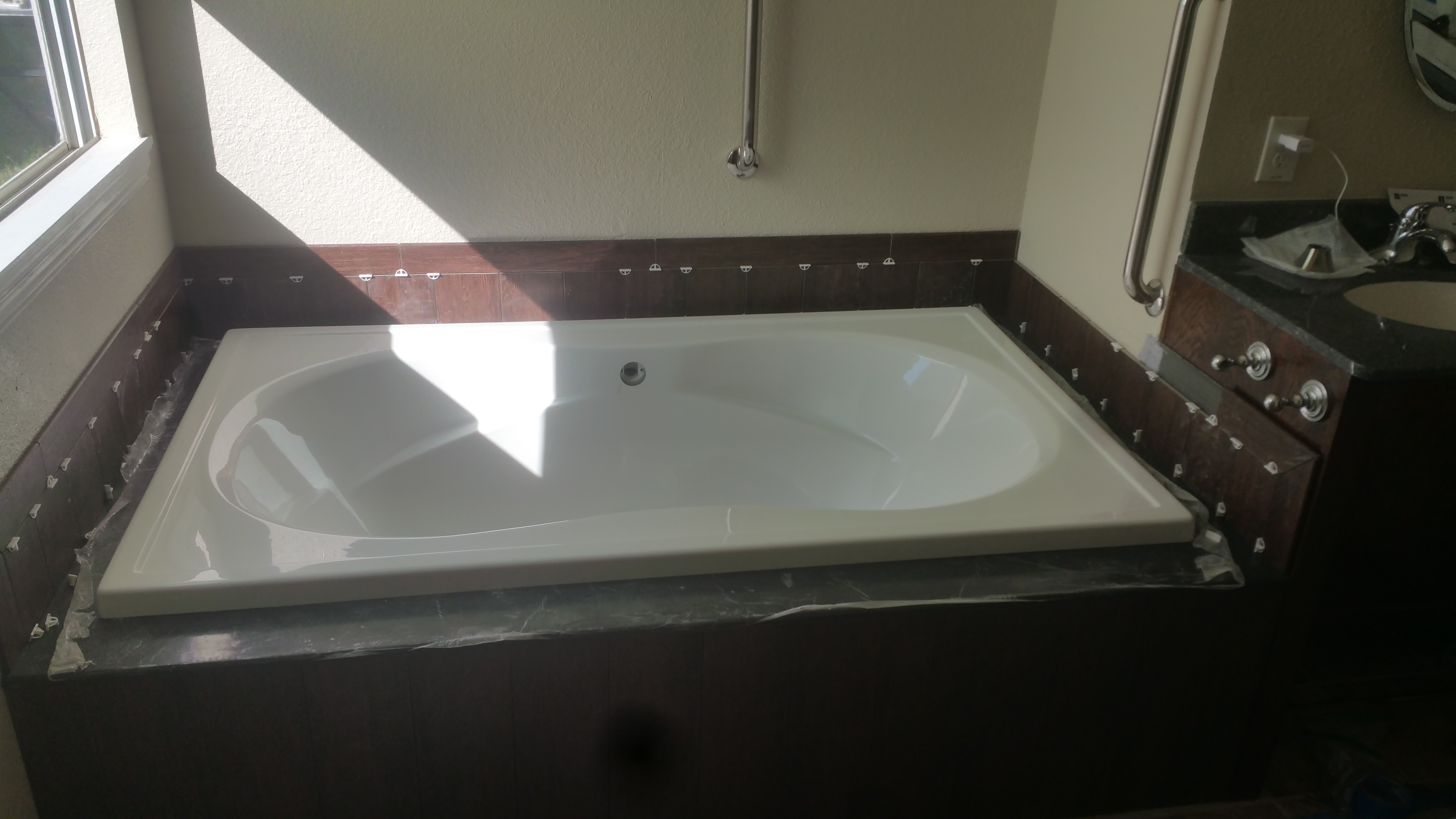 Garden tub with tiled wood surround