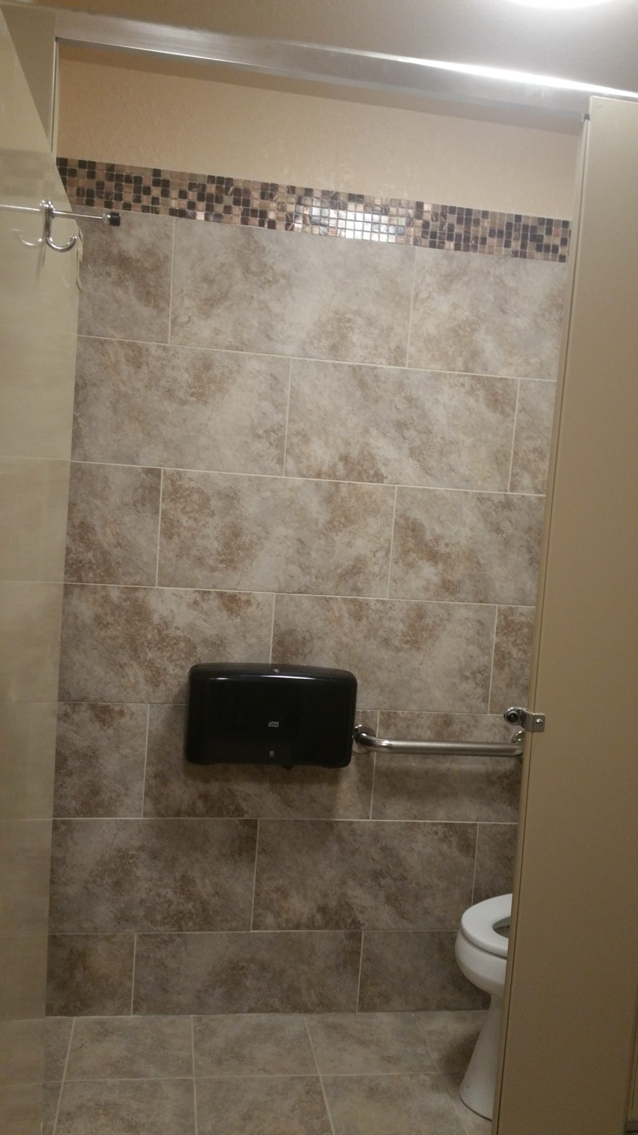 Commercial restroom with an ADA grab bar