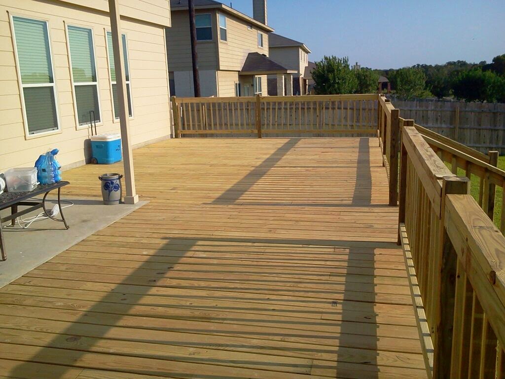 Large pressure-treated deck with a full railing