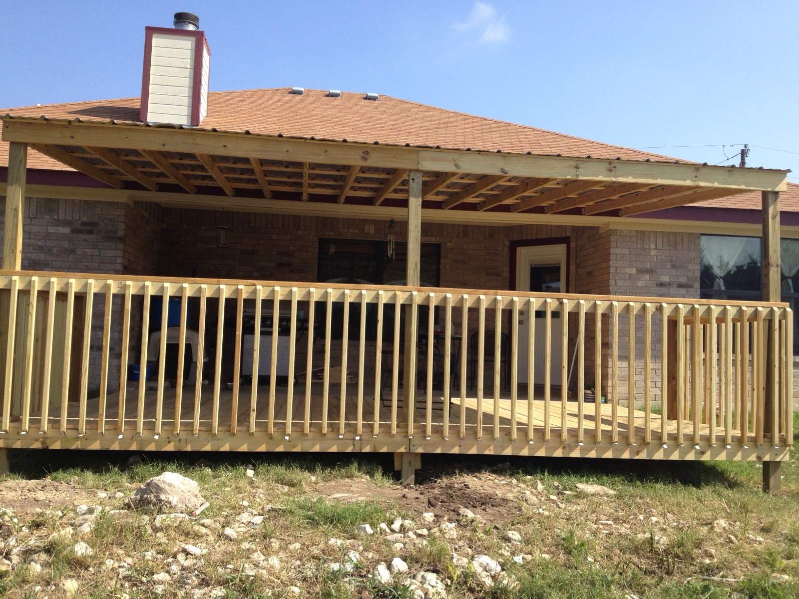 Pine patio cover over a deck on a brick home