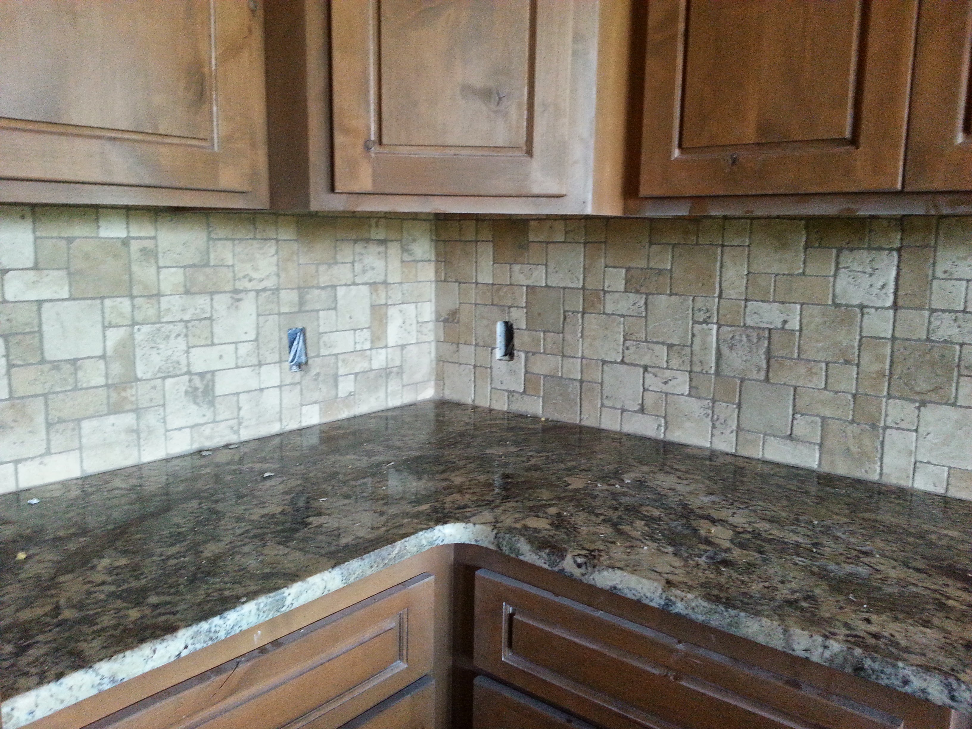 Kitchen with travertine backsplash and granite counters